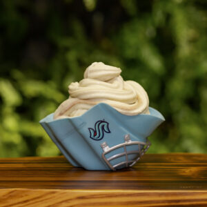 Soft serve ice cream in a mini souvenir goalie mask on wood tray