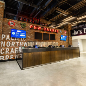 brick wall with neon letters that say PNE DRAFTS with 12 draft handles